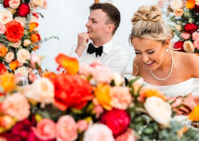 couple laughing surrounded by flowers